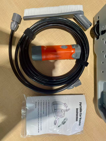 12V portable orange pressure washer cleaning an outdoor air conditioner unit with 15L water tank and adjustable spray gun